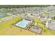 Aerial view of a community pool with lounge chairs, a playground, and ample parking at 6013 Mount Zion Cir, Deland, FL 32724
