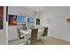 Bright dining room featuring a contemporary chandelier, large window, and sleek grey chairs at 6013 Mount Zion Cir, Deland, FL 32724