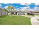 Lovely single-story home with beautiful landscaping, brick driveway and a green lawn under a beautiful sky at 6013 Mount Zion Cir, Deland, FL 32724