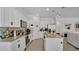 Well-lit kitchen featuring white cabinets, stainless steel appliances, and a functional center island at 6013 Mount Zion Cir, Deland, FL 32724