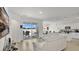 Open-concept living area with a modern white sectional, sliding glass doors, and access to the kitchen at 6013 Mount Zion Cir, Deland, FL 32724