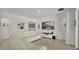 Bright living room with white interior, a large television, and a comfortable white sectional couch at 6013 Mount Zion Cir, Deland, FL 32724