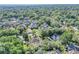 A serene aerial view reveals the home nestled among mature trees in a quiet residential neighborhood at 612 Golden Dawn, Apopka, FL 32712