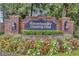 Elegant brick sign for Sweetwater Country Club surrounded by colorful flowers and lush landscaping at 612 Golden Dawn, Apopka, FL 32712