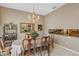 Formal dining area featuring elegant chandelier, decorative mirror, neutral paint, and adjacent bar at 612 Golden Dawn, Apopka, FL 32712