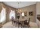 Formal dining room featuring elegant chandelier, decorative mirror, neutral paint, and classic dining set at 612 Golden Dawn, Apopka, FL 32712
