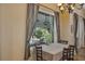 This elegant dining room features views of the pool, with a chandelier and neutral decor at 612 Golden Dawn, Apopka, FL 32712