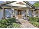 Charming front entry boasts decorative wood door, sidelights, manicured landscaping, and brick paver walkway at 612 Golden Dawn, Apopka, FL 32712