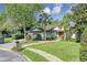 Charming single-story home with lush landscaping, mature trees, and a well-manicured lawn at 612 Golden Dawn, Apopka, FL 32712