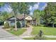 Charming single-story home with a brick pathway leading to a covered front porch and well-manicured landscaping at 612 Golden Dawn, Apopka, FL 32712