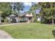 Charming single-story home features a lush lawn, palm trees, and a brick walkway leading to the inviting front entrance at 612 Golden Dawn, Apopka, FL 32712