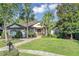 Charming single-story home with lush landscaping, mature trees, and a well-manicured lawn at 612 Golden Dawn, Apopka, FL 32712