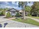 Charming single-story home features a lush lawn, palm trees, and a brick walkway leading to the inviting front entrance at 612 Golden Dawn, Apopka, FL 32712