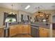 Bright kitchen with stainless steel appliances, granite countertops, open to living room, and chandelier at 612 Golden Dawn, Apopka, FL 32712