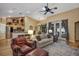Spacious living room with a view of the kitchen bar, stainless steel appliances, and outdoor patio through glass doors at 612 Golden Dawn, Apopka, FL 32712
