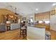 Open-concept living space featuring kitchen, fireplace, wood floors, and comfortable seating at 612 Golden Dawn, Apopka, FL 32712