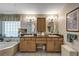 Bright main bathroom with double sinks, vanity, soaking tub, and granite countertops at 612 Golden Dawn, Apopka, FL 32712