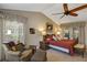 Spacious main bedroom with vaulted ceiling, ceiling fan, and cozy seating area and accent pillows at 612 Golden Dawn, Apopka, FL 32712