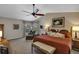 Spacious main bedroom with vaulted ceiling, ceiling fan, and cozy seating area and accent pillows at 612 Golden Dawn, Apopka, FL 32712