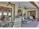 Covered outdoor patio area featuring comfortable seating, ceiling fans, and elegant lighting for relaxing and entertaining at 612 Golden Dawn, Apopka, FL 32712