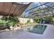 Screened-in pool area featuring a sparkling swimming pool, plants, and lounge chairs at 612 Golden Dawn, Apopka, FL 32712