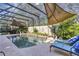 Enjoy the sun and shade at this screened in-ground pool with lounge chairs and decorative landscaping at 612 Golden Dawn, Apopka, FL 32712