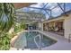 Beautiful screened in-ground pool is accessible to the outdoor dining area and surrounded by lush plants at 612 Golden Dawn, Apopka, FL 32712