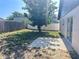 Backyard with mature tree and partial view of the back of the home at 6554 Meritmoor Cir, Orlando, FL 32818