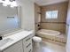 Bathroom features a soaking tub, neutral tiling and modern fixtures at 6554 Meritmoor Cir, Orlando, FL 32818