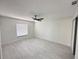 Spacious bedroom with white tile flooring and a ceiling fan at 6554 Meritmoor Cir, Orlando, FL 32818