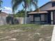View of front yard with palm tree and the side of the house with a window at 6554 Meritmoor Cir, Orlando, FL 32818