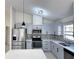 Bright kitchen featuring gray cabinets, stainless steel appliances, and plenty of counter space at 6554 Meritmoor Cir, Orlando, FL 32818