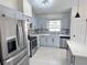 Stylish kitchen with stainless steel appliances, shaker cabinets, and a quartz countertop at 6554 Meritmoor Cir, Orlando, FL 32818