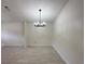 Living room with white walls, and an elegant ceiling light fixture at 6554 Meritmoor Cir, Orlando, FL 32818