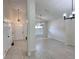 Open-concept living space featuring neutral colors, vaulted ceilings, and tile flooring at 6554 Meritmoor Cir, Orlando, FL 32818