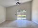 Inviting living room with tile floors and sliding glass doors leading to the backyard at 6554 Meritmoor Cir, Orlando, FL 32818