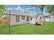 Landscaped backyard features lush grass, wooden fence, and exterior of a white home at 708 S Laurel Ave, Sanford, FL 32771