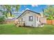 Green backyard with lush grass, wooden deck, and exterior of a white home at 708 S Laurel Ave, Sanford, FL 32771