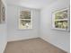 Small bedroom with natural light, neutral carpet, white walls, and window blinds at 708 S Laurel Ave, Sanford, FL 32771
