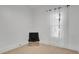 Sparse bedroom features chair, natural light, neutral carpet, and white walls at 708 S Laurel Ave, Sanford, FL 32771