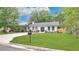 Charming single-story home with a manicured lawn, a concrete driveway, and a black mailbox at 708 S Laurel Ave, Sanford, FL 32771
