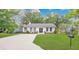 Charming single-story home with a manicured lawn, a concrete driveway, and fresh landscaping at 708 S Laurel Ave, Sanford, FL 32771