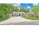 Charming single-story home with a large driveway and well-manicured lawn, framed by mature trees at 708 S Laurel Ave, Sanford, FL 32771