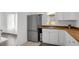 Modern kitchen features stainless steel refrigerator, white cabinets, and butcher block countertops at 708 S Laurel Ave, Sanford, FL 32771