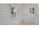 Small laundry room with white wood paneling, a window, and washer/dryer hookups at 708 S Laurel Ave, Sanford, FL 32771
