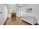 Bright living room featuring hardwood floors, white sofa, and a classic brick fireplace at 708 S Laurel Ave, Sanford, FL 32771