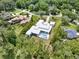 Aerial shot of a contemporary home with a pool, situated on a large lot surrounded by mature trees at 7615 Se 12Th Cir, Ocala, FL 34480