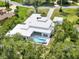 Beautiful backyard with a luxurious pool and hot tub, surrounded by lush landscaping providing privacy and relaxation at 7615 Se 12Th Cir, Ocala, FL 34480