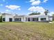 Wide view of the home's backyard and exterior showing modern design at 7615 Se 12Th Cir, Ocala, FL 34480
