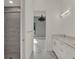 Bathroom view to Primary bedroom with marble look tiles, shower, and double vanity at 7615 Se 12Th Cir, Ocala, FL 34480